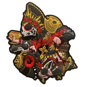 May include: A black, red and gold embroidered patch featuring a skull wearing a sombrero and holding a chalice. The skull is surrounded by roses and other decorative elements.