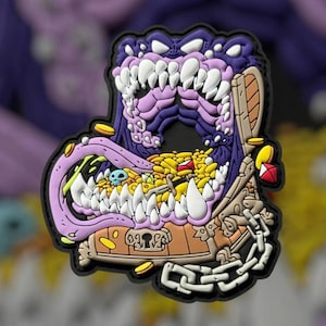 May include: A purple and black monster with sharp teeth is bursting out of a wooden treasure chest. The chest is overflowing with gold coins, gems, and other treasures. The monster's tongue is sticking out and has a skull on it.