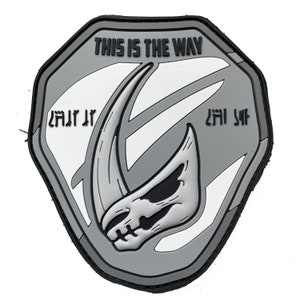 May include: A grey and white patch with a Mandalorian symbol and the text "This is the Way".