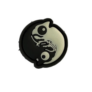 May include: Black and white yin yang symbol with a stylized fish design on each side.