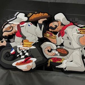 May include: Two cartoon chef patches, one with a French flag and the other with an Italian flag. Each chef is holding plates of food, including pasta, cake, and lobster. The chefs wear white coats and hats.
