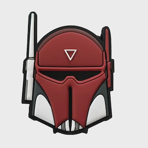 Könnte beinhalten: Ein rot-weiß-schwarzes zubehör in Helmform. Das Design zeigt einen roten Helm mit einem weißen Dreieck und weißen und schwarzen Akzenten. Das Zubehör hat einen schwarzen Rand und ist wahrscheinlich ein Sammler- oder Dekorationsartikel.