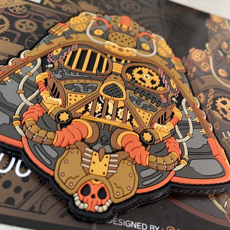 May include: A steampunk-style Darth Vader helmet patch with intricate details in gold, brown, and orange. The patch features gears, pipes, and other mechanical elements.