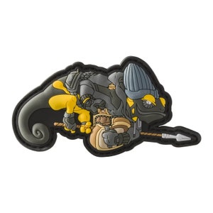 May include: A patch featuring a stylized chameleon warrior in shades of gray, yellow, and tan, with a spear. The chameleon is wearing armor and a beanie. The patch has a black border and is set against a white background.