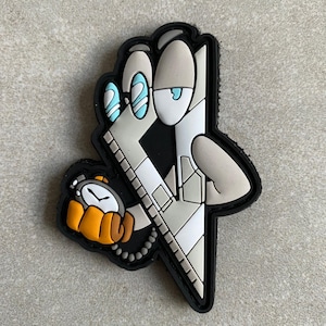 May include: A cartoon patch featuring a character with a stopwatch. The character has a grey and white design with blue eyes and is holding a stopwatch with an orange and brown hand. The patch has a black border.