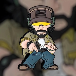 May include: A cartoon-style figure of a man in a military-style outfit, wearing a cap with an American flag, yellow visor, and a watch. He is holding a gun and wearing a green jacket, white shirt, and blue jeans. The figure is in a standing pose.
