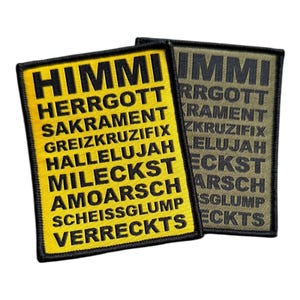 May include: Two fabric patches with black text on a yellow and green background. The text on the yellow patch reads "HIMMI HERRGOTT SAKRAMENT GREIZKRUZIFIX HALLELUJAH MILECKST AMOARSCH SCHEISSGLUMP VERRECKTS". The text on the green patch reads "IMMI RRGOTT RAMENT ZKRUZIFIX ELUJAH ECKST ARSCH SGLUMP ECKTS".