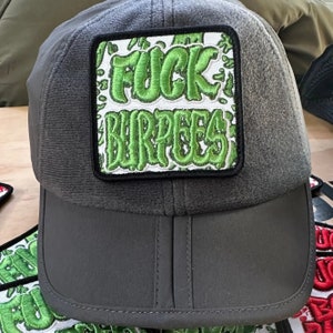 May include: A gray and black baseball cap with a green embroidered patch that says "FUCK BURPEES".