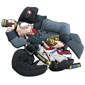 May include: A cartoon-style figurine of a man in a Napoleonic era uniform, holding a spyglass. The figure is primarily gray, black, white, and red, with gold accents. The word "GARDE" is printed on a sword.