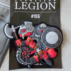 May include: A red, black and grey chameleon wearing armour and holding a sword and axe. The chameleon is part of a legion, as indicated by the text "Legion #155".
