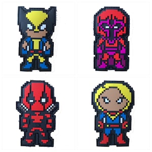May include: Four pixel art style iron-on patches featuring characters from Marvel Comics. The patches are black with colorful details. The characters are Wolverine, Magneto, Deadpool, and Captain Marvel.