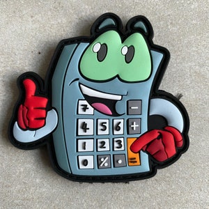 May include: A cartoon calculator character with a light blue body, black trim, and a green face. It has a thumbs-up gesture and a red hand pressing the equals button. The calculator displays numbers and symbols, and has a smiling face.