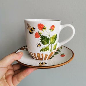 Hand made a mug and saucer- painted. The sunny pattern with bumblebee will create a joyful mood in any bad weather your kitchen