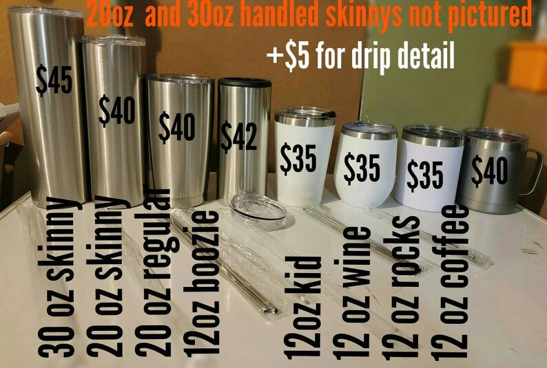 May include: A selection of stainless steel and white tumblers in various sizes and prices. The tumblers are displayed on a white surface. The text "20oz and 30oz handled skinnys not pictured +&pound;5 for drip detail" is visible at the top of the image.
