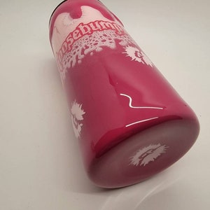 May include: A pink stainless steel tumbler with a white design that says "Choose Human" in a stylised font. The tumbler has a white splatter design.