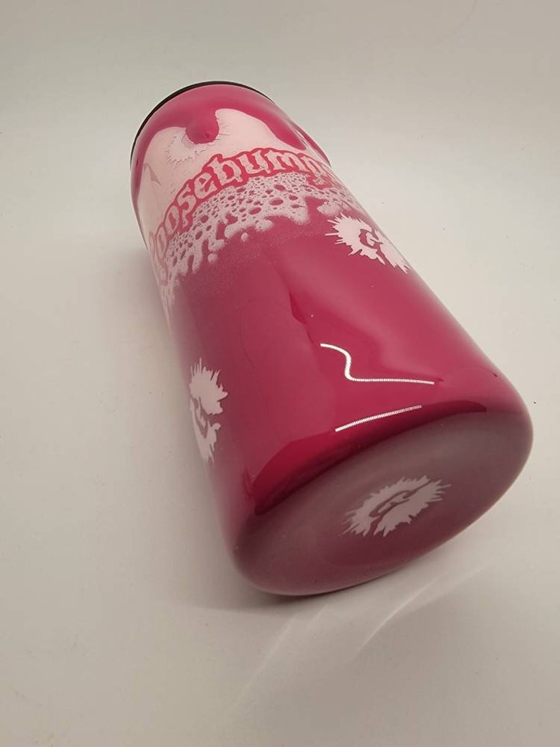 May include: A pink stainless steel tumbler with a white design that says "Choose Human" in a stylised font. The tumbler has a white splatter design.
