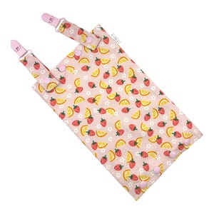 May include: A pink fabric bag featuring a pattern of strawberries, lemon slices, and white flowers. It has two pink clips and pink press-stud closures. The bag is designed for small items.