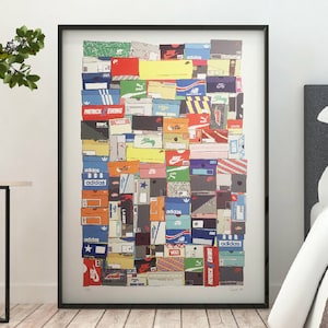 May include: A framed art print depicting a collage of sneaker boxes. The boxes are arranged together, displaying a variety of colours, logos, and brand names, including Adidas, Nike, and Patrick Ewing. The artwork is presented in a black frame.