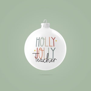 May include: White Christmas ornament with the text "HOLLY JOLLY Teacher" in colorful lettering.