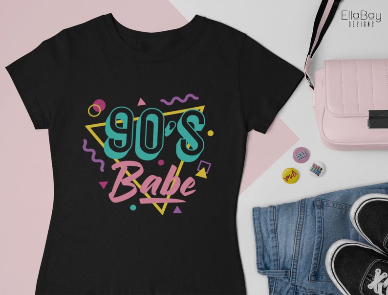 May include: Black t-shirt with a graphic design of a triangle with the text "90's Babe" in colorful letters and geometric shapes.