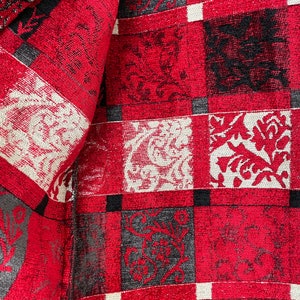 May include: Red, black, and white checkered fabric with a floral pattern. The fabric has a textured surface.