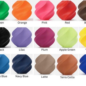 May include: A collection of twenty-one decorative, swirled spheres in various colors, including gray, green, orange, pink, red, brown, and mistletoe green. Additional colors are bronze, black, lilac, plum, apple green, yellow, turquoise, dark green, marine blue, navy blue, latte, terra cotta, blue, and sky blue.