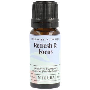 May include: A brown glass bottle with a black cap, labelled "PURE ESSENTIAL OIL BLEND Refresh & Focus Bergamot, Eucalyptus, Lavender (French) & Lemon 0.34fl.oz NIKURA 10ml"