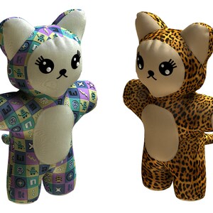 May include: Two plush cat toys, one with a geometric pattern and the other with a leopard print. Both toys have large eyes and a cute expression.
