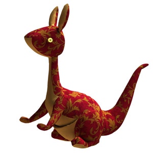 May include: A red and gold plush kangaroo toy with a floral pattern. The kangaroo is sitting with its tail curled behind it.