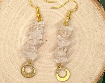 May include: Gold earrings with clear quartz stones and gold circle charms.