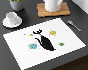 May include: White placemat with a black cat silhouette and colorful mid-century modern style starbursts.