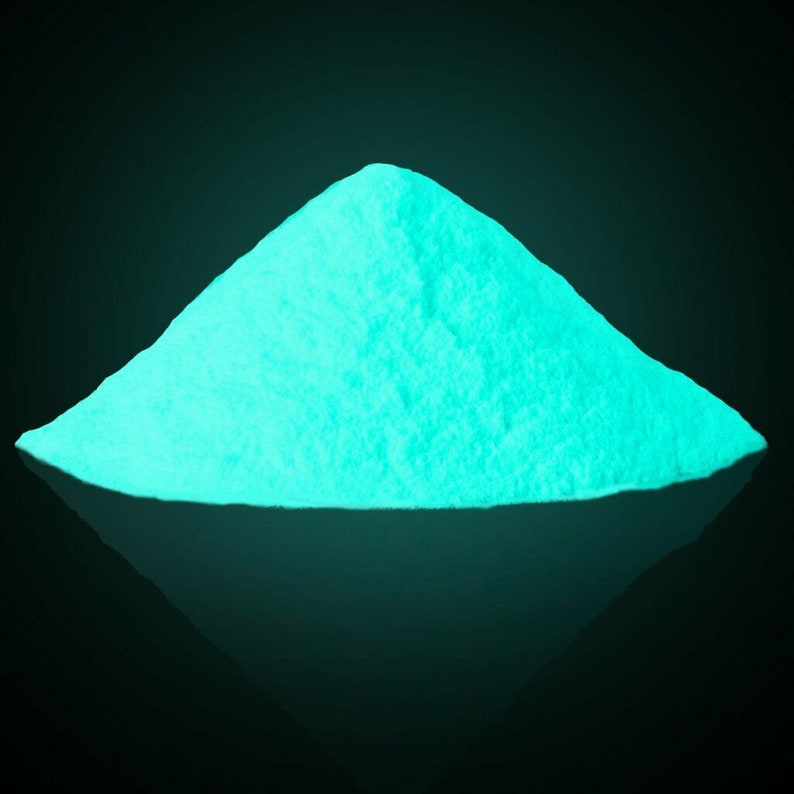 May include: A pile of bright turquoise glow-in-the-dark powder.