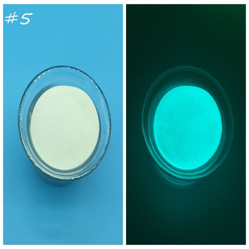 May include: A white glow-in-the-dark powder in a clear glass bowl. The powder glows a bright teal green in the dark.