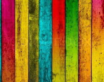 May include: A close-up of a wooden wall with vertical planks painted in a rainbow of colours, including red, orange, yellow, green, blue, and purple.