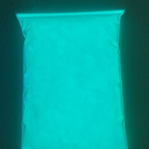 May include: A plastic bag filled with bright turquoise glow-in-the-dark powder.