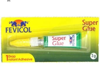 May include: A yellow and green tube of Fevicol Super Glue, a 1-drop instant adhesive. The tube is labeled "Super Glue" and "Fevicol" with two elephants on the packaging. The packaging is yellow with green text and a green background.