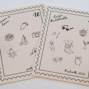May include: Two cream-colored cards with black line drawings of travel and party-themed icons. One card says "Summer in Spain" and the other says "Lucy's Bachelorette Nashville 2025". Each card has a stamp-like border.