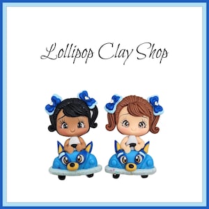 Girl in blue dog car for bows- Clay Bow Center clay doll, clay dolls, bow centerpieces, clay center for bows, bow center, puppy clays