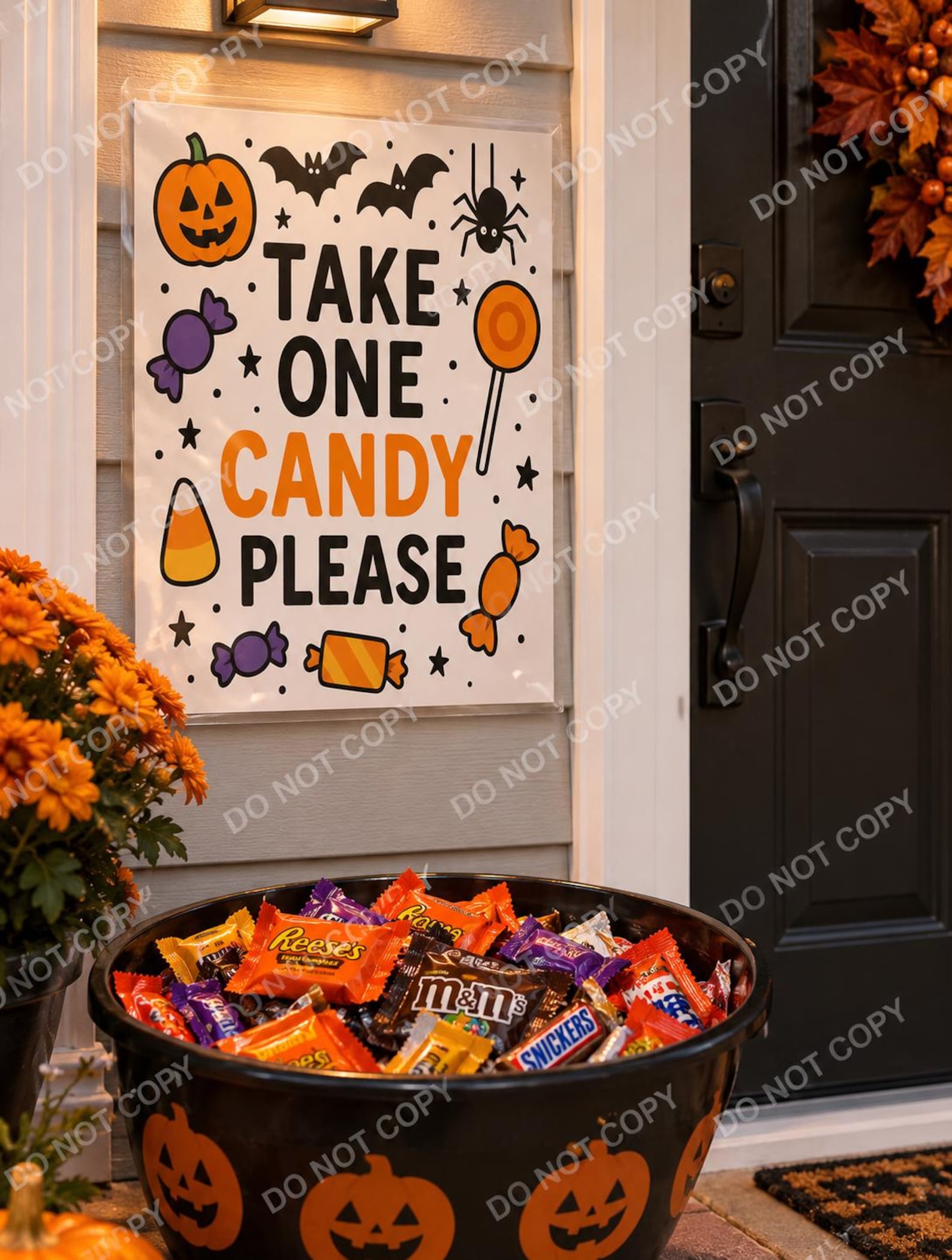An Orange Take-One Clipboard Orange Halloween take-one sign displayed on a clipboard beside a candy bowl.