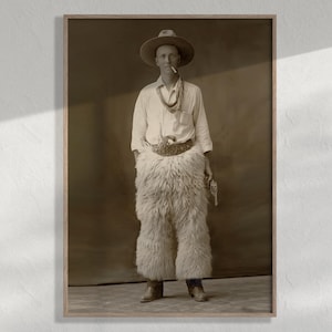 May include: A sepia-toned vintage photograph of a person wearing a wide-brimmed hat, a light-colored button-down shirt, a neckerchief, and long, shaggy fur chaps. The person holds a cigarette in their mouth and a revolver in their hand.