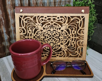 May include: A wooden stand with a laser-cut design, featuring a burgundy mug and glasses. The stand has a leather-like top and a decorative pattern.