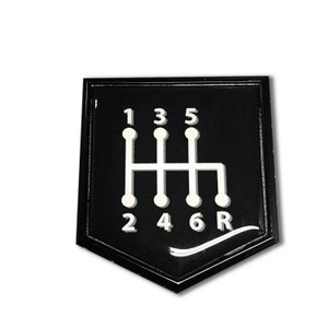 May include: Black and white gear shift pattern sticker with numbers 1, 2, 3, 4, 5, 6, and R.
