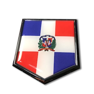 May include: A chrome-plated emblem featuring the Dominican Republic flag. The flag is red, white, and blue with the national coat of arms in the center.