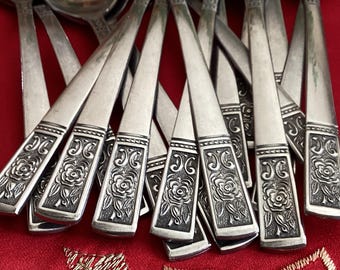 May include: A set of silver-plated flatware with a floral design. The handles are decorated with a raised pattern of roses and leaves.