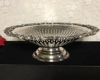 May include: A silver-plated, openwork fruit bowl with a scalloped edge and a pedestal base.