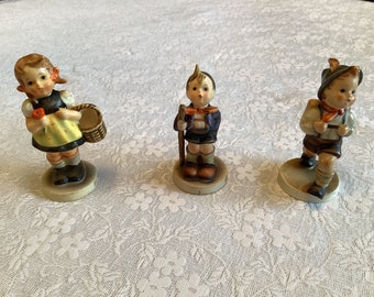 Hummel Figurines Girl With Basket Boy With Walking Stick And Boy With Backpack