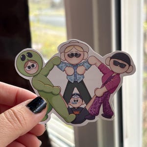 May include: A sticker featuring four cartoon characters. The characters are a green alien, a blonde person wearing sunglasses, a person with black hair wearing sunglasses and a pink and purple shirt, and a person with black hair wearing a blue shirt and a diving mask. The characters are arranged in a circle, with the alien at the top.