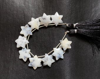 May include: A strand of white and grey star-shaped gemstone beads with silver wire and black tassels.