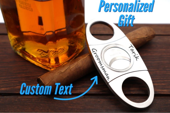 A vintage-style personalized cigar cutter with 31 favorites — small, affordable, and something a cigar guy will actually pull out and show off.