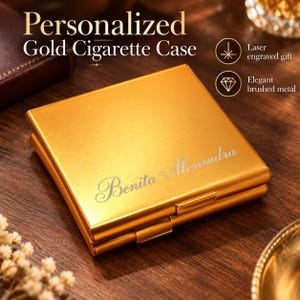 May include: A square gold cigarette case with a brushed metal finish. The front features the laser-engraved name Benita Alexandra in a cursive script. The text Personalized Gold Cigarette Case, Laser engraved gift, and Elegant brushed metal appear.